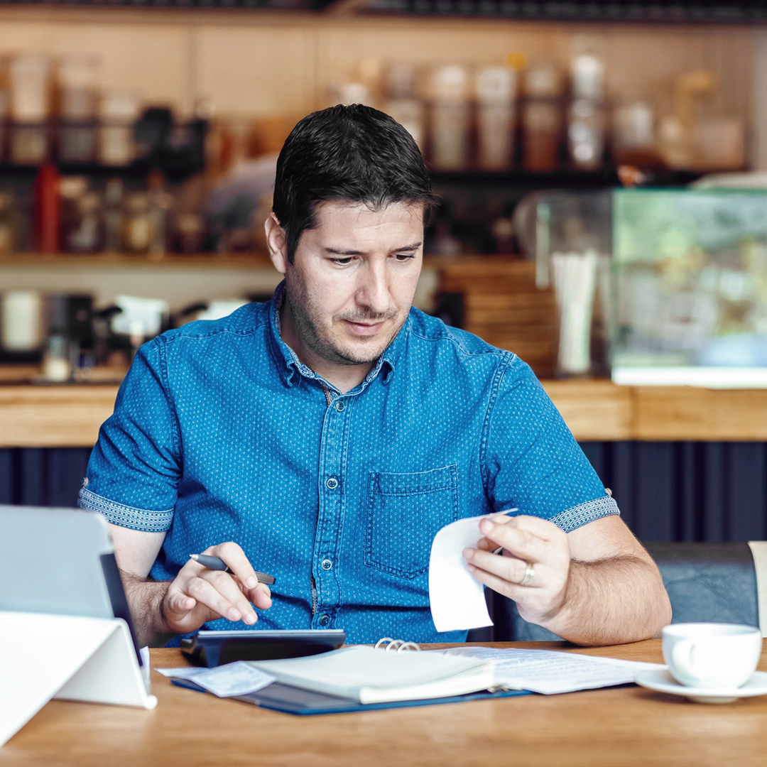 Employee with paperwork at desk