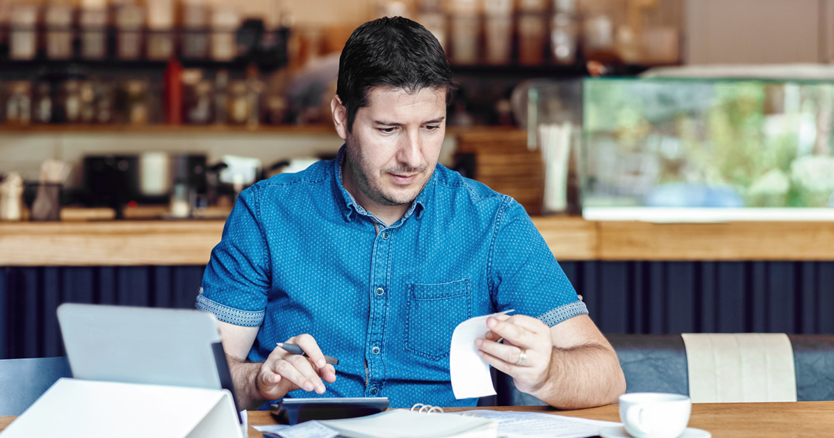 Employee with paperwork at desk