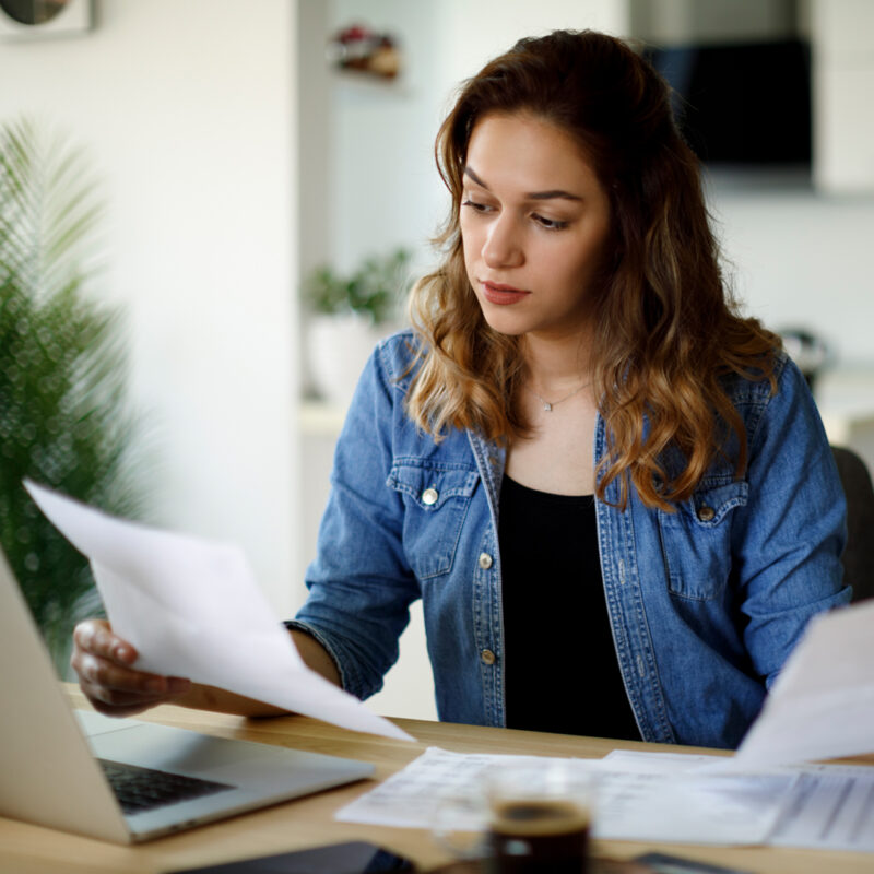 Woman reviewing her taxes in front of a computer