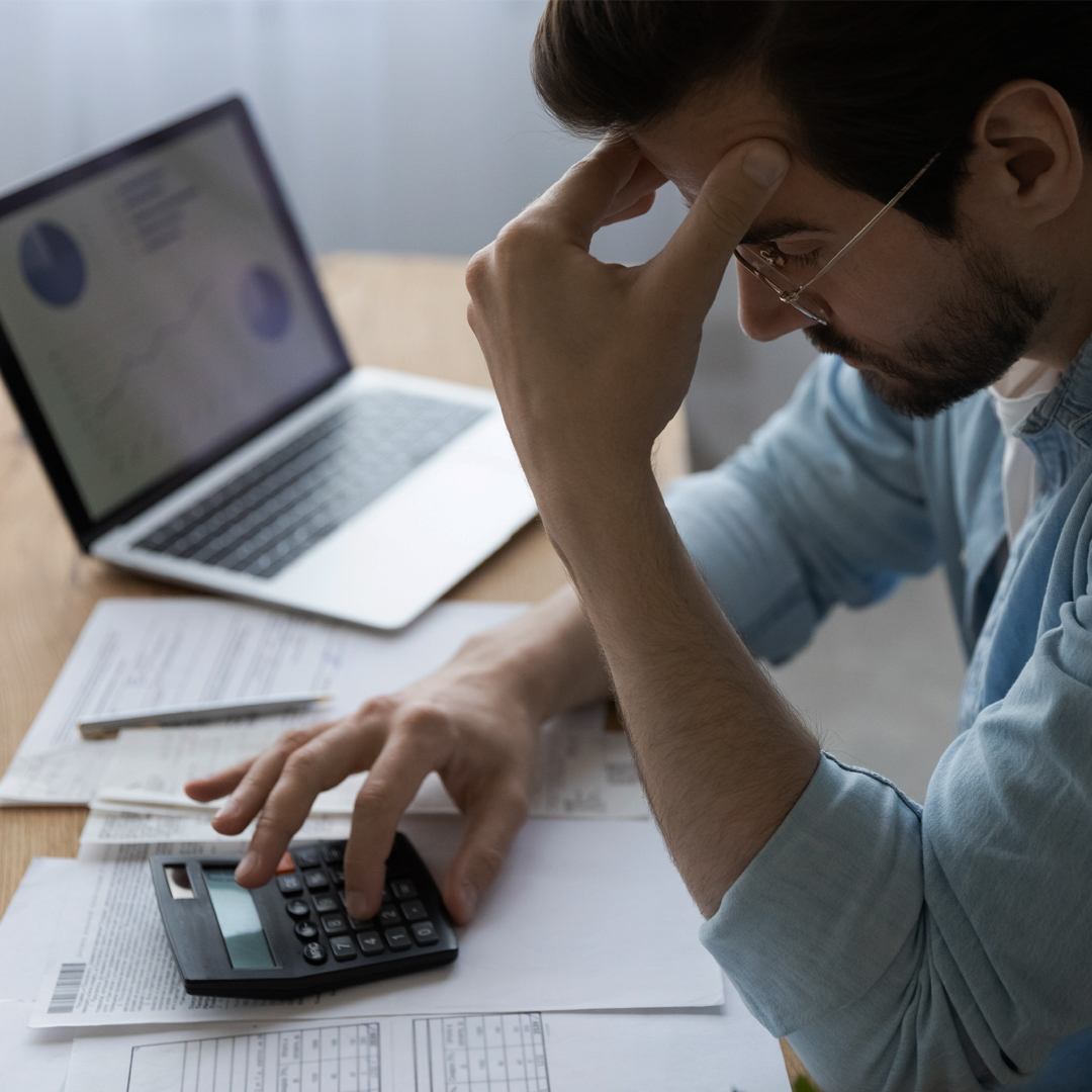 Man frustrated using calculator