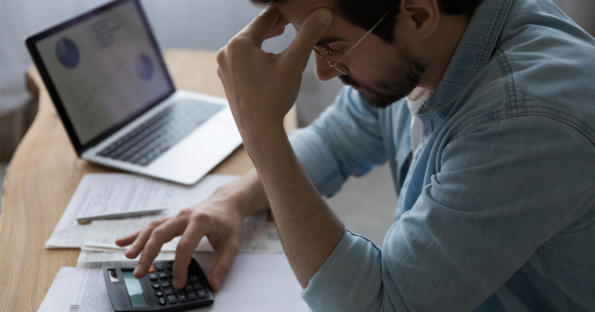 Man frustrated using calculator